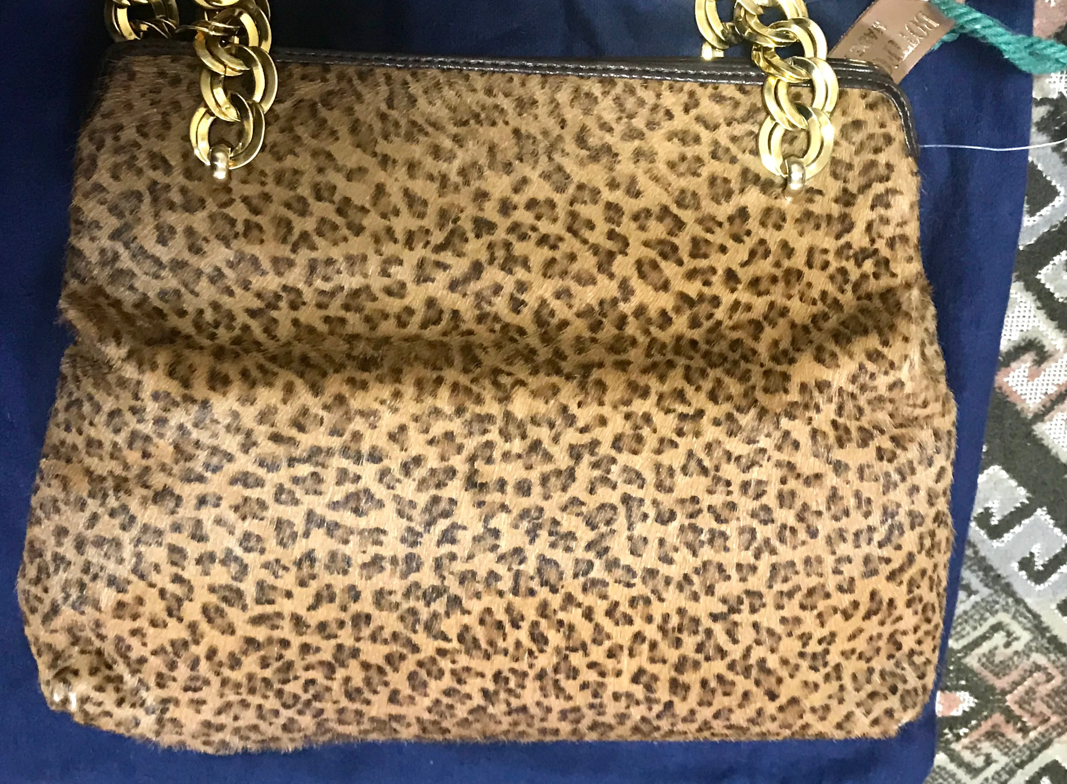 Vintage Bottega Veneta genuine leather shoulder bag with allover faux leopard print and double golden chain straps.